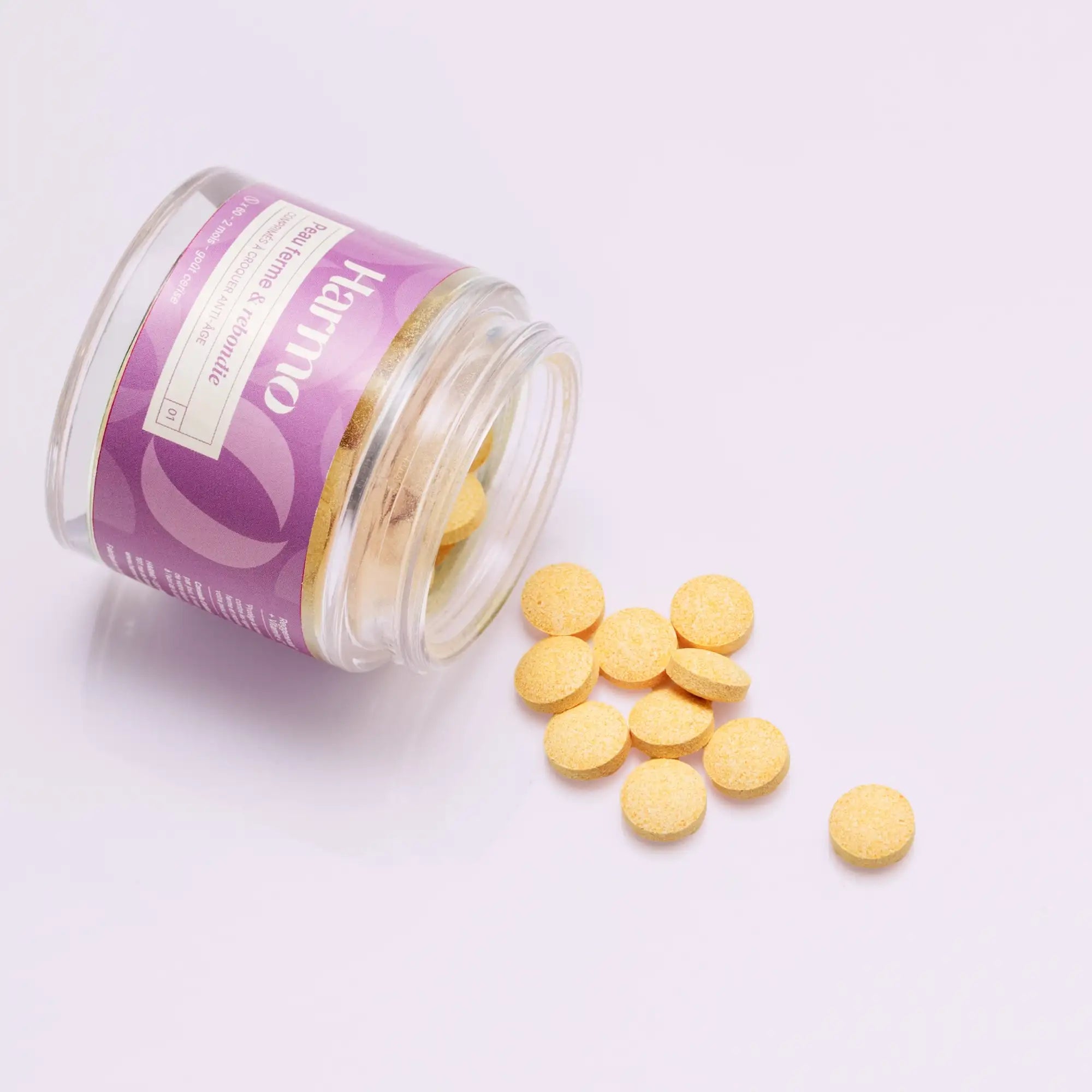 Pot de comprimés à croquer anti-âge renversé pour qu'on voit les comprimés  Image